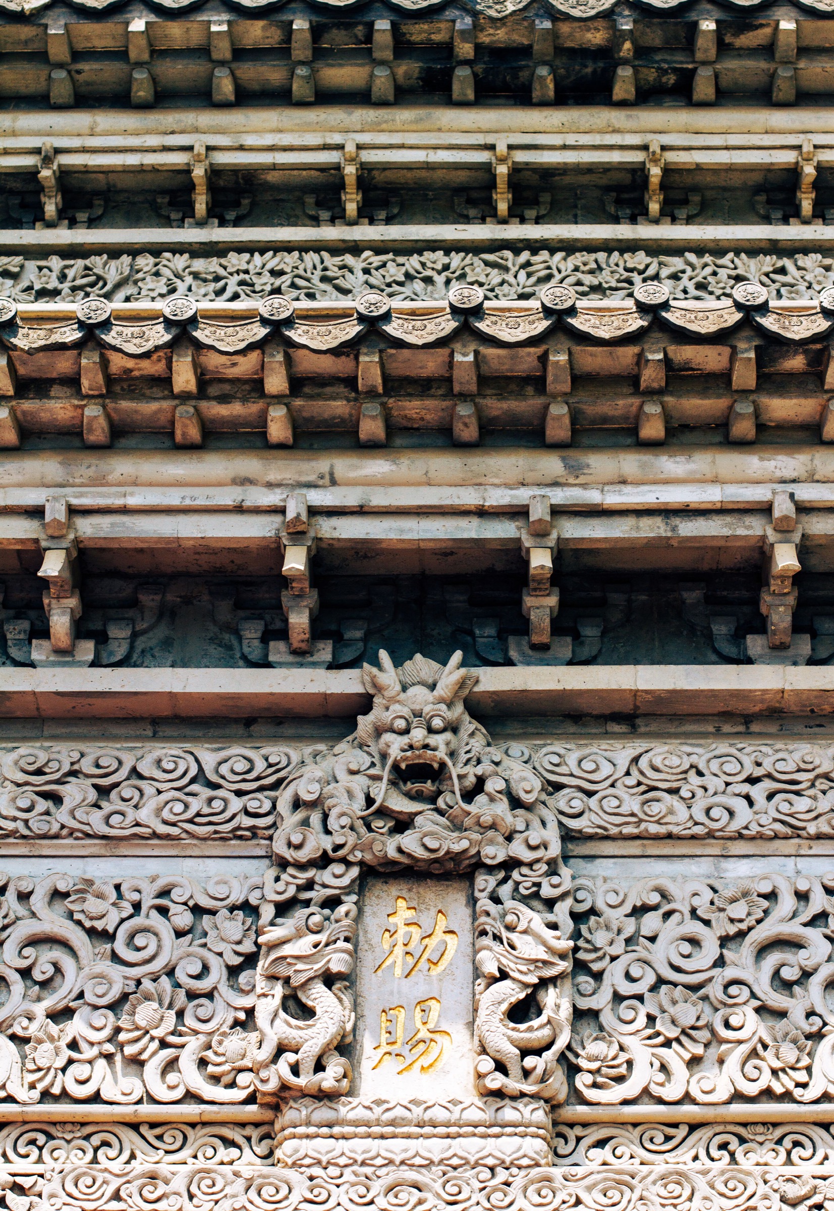 Ornate traditional Chinese roof eaves and carved stone detail